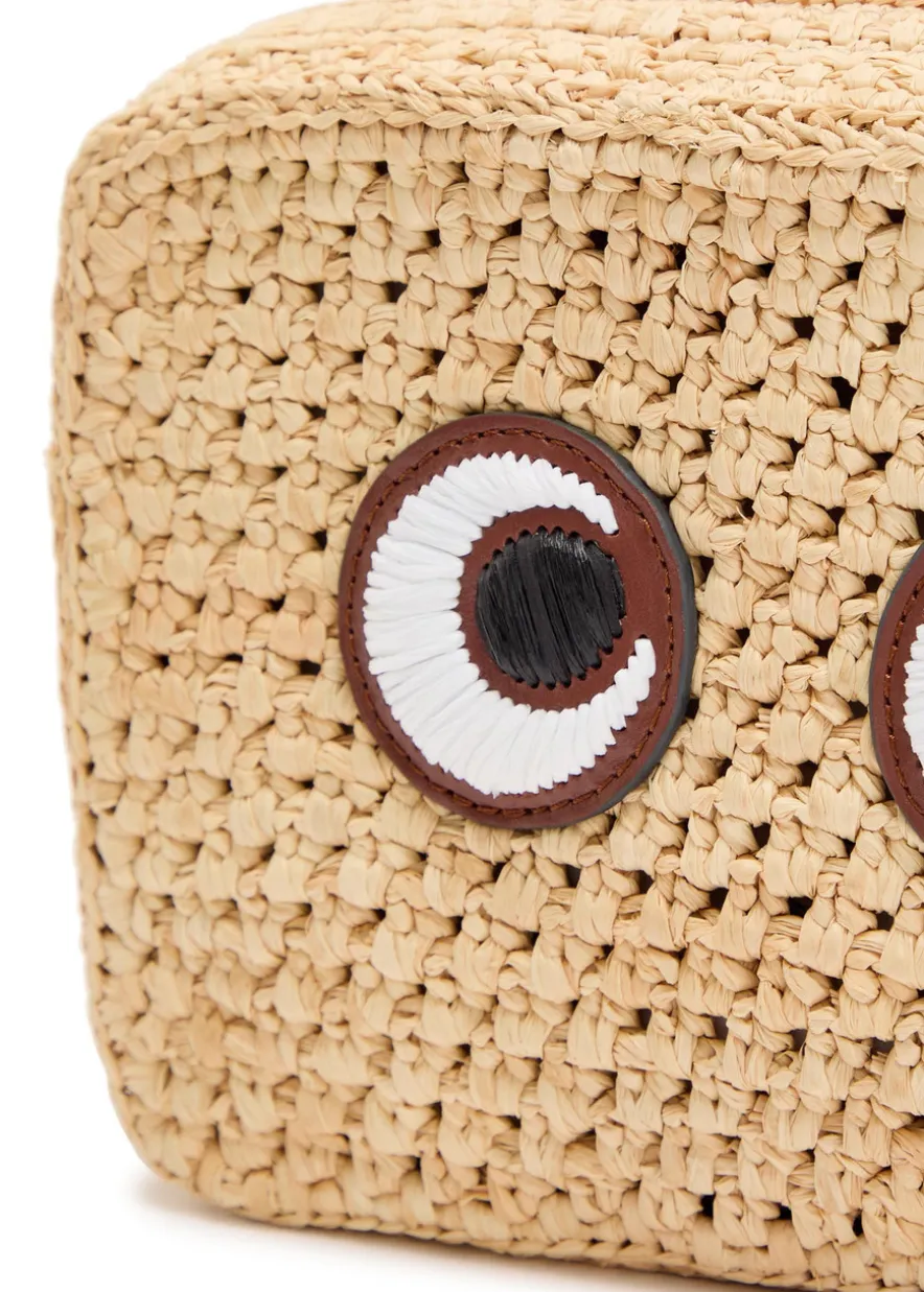Eyes appliquéd raffia cross-body bag