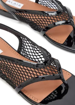 Fishnet patent leather thong sandals