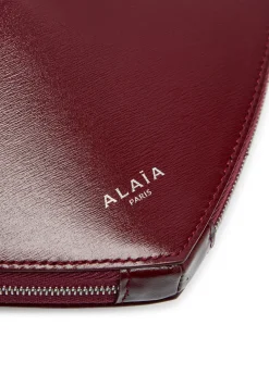 Le Couer glossed leather cross-body bag