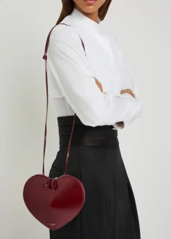 Le Couer glossed leather cross-body bag
