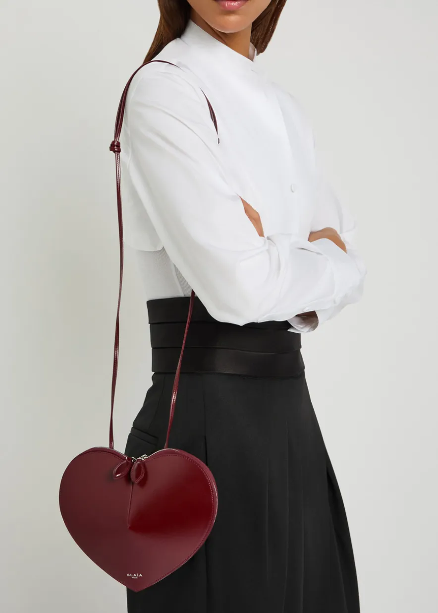 Le Couer glossed leather cross-body bag