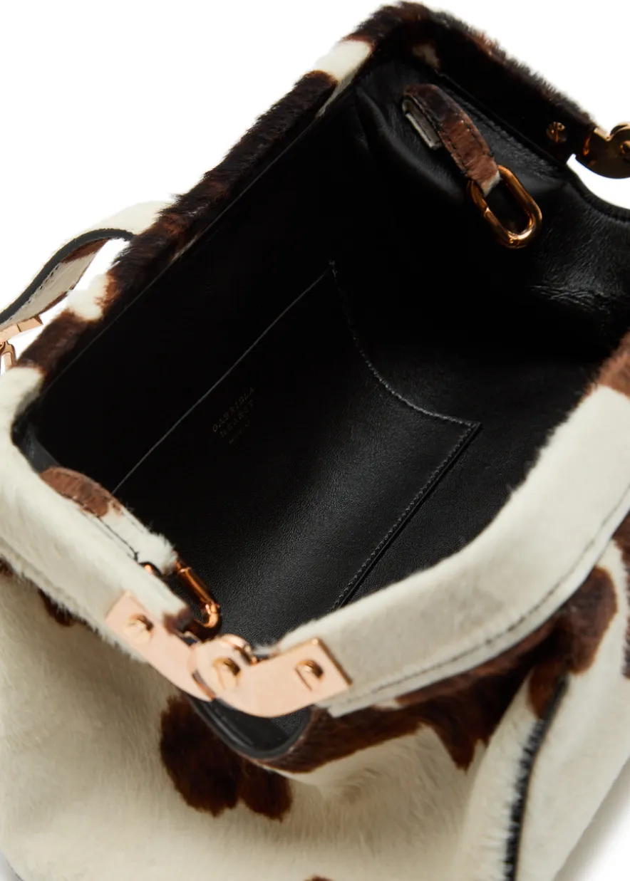 Paola cow-print calf-hair clutch
