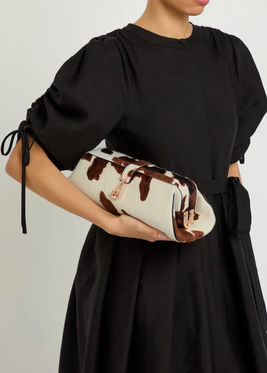 Paola cow-print calf-hair clutch