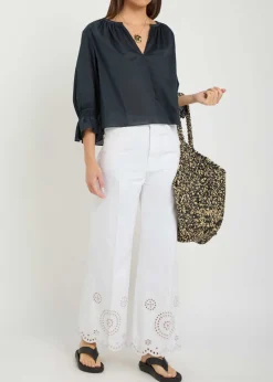 The Eyelet Flare embroidered flared-leg jeans